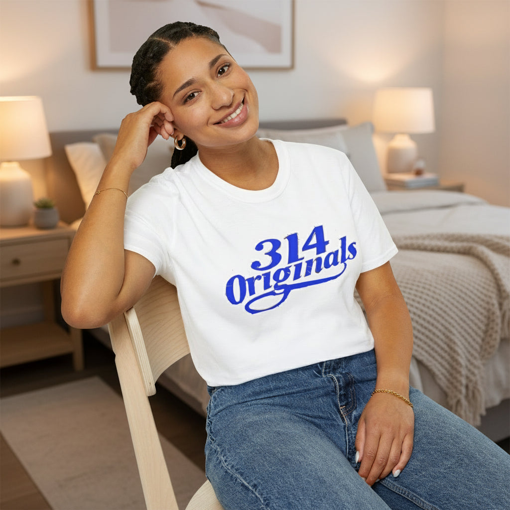 Person wearing a white t-shirt with '314 Originals' in blue text, sitting on a chair.