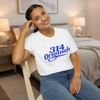 Person wearing a white t-shirt with '314 Originals' in blue text, sitting on a chair.