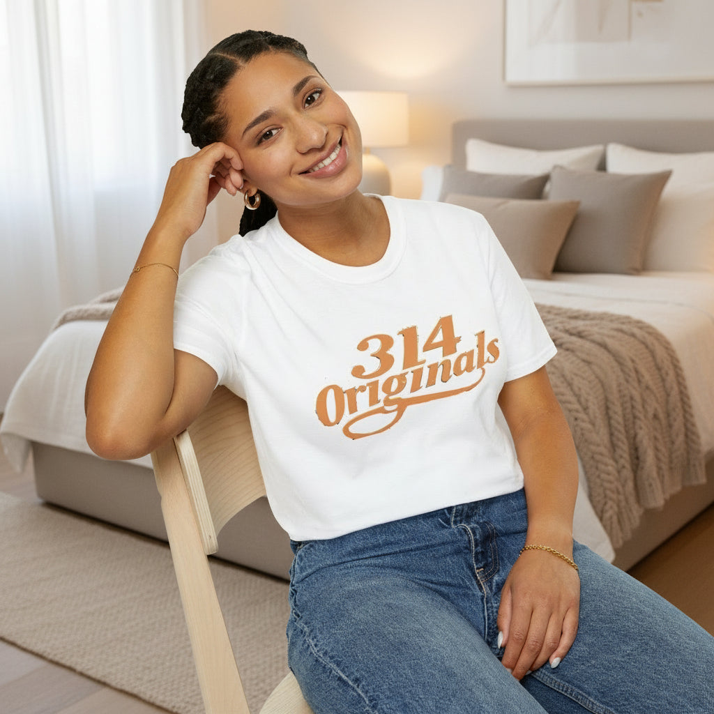 Person wearing a white t-shirt with '314 Originals' text, sitting on a chair.